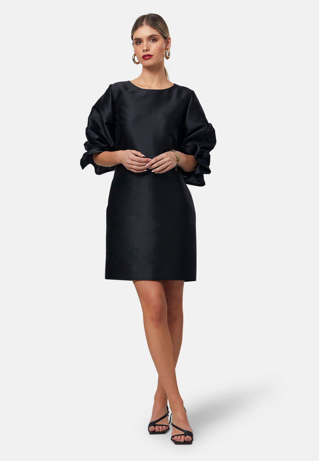 Step into the spotlight with Aurora, a chic short-shift dress in bold black. This stylish piece features a statement puff-ball sleeve, side seam pockets, and falls just above the knee. Crafted from a silk blend taffeta. Make a grand entrance with Aurora, perfect for a soiree or formal dressing.