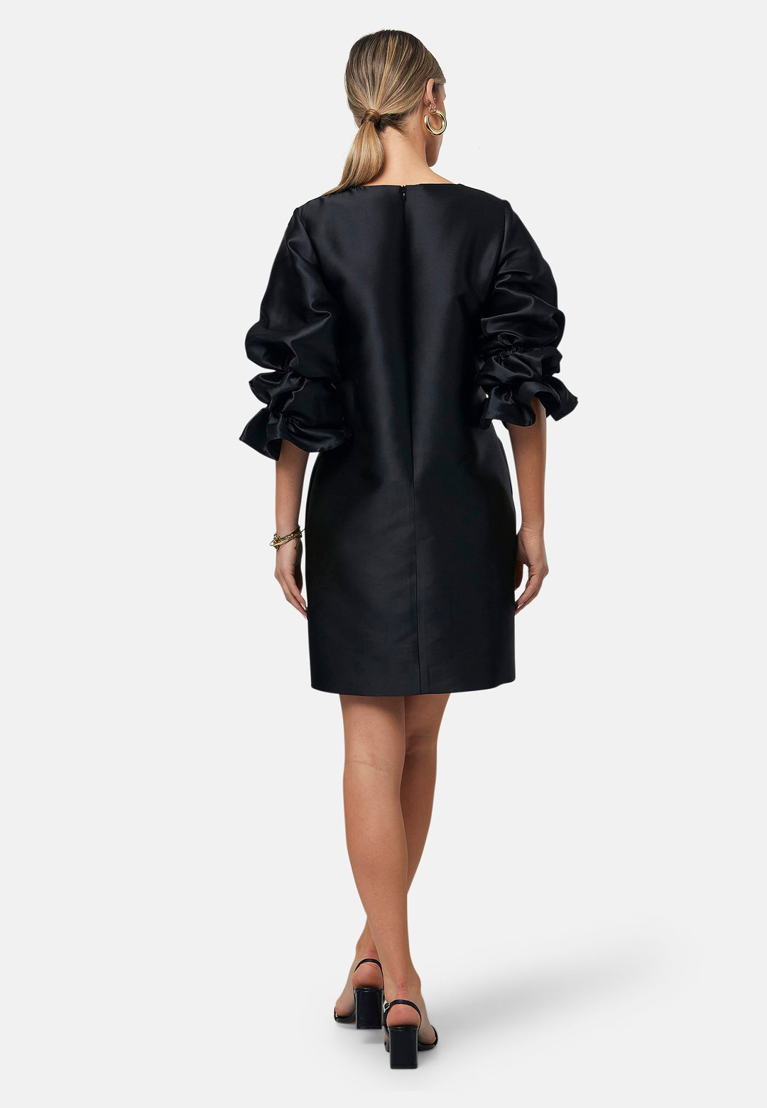 Step into the spotlight with Aurora, a chic short-shift dress in bold black. This stylish piece features a statement puff-ball sleeve, side seam pockets, and falls just above the knee. Crafted from a silk blend taffeta. Make a grand entrance with Aurora, perfect for a soiree or formal dressing.