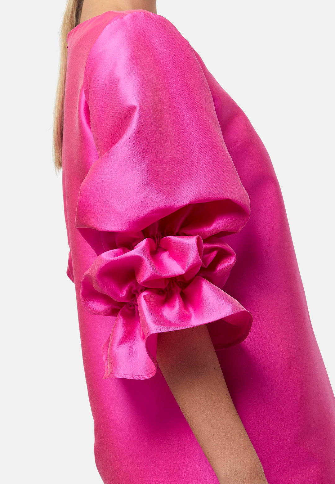 Step into the spotlight with Aurora, a chic short-shift dress in bold Fuchsia. This feminine piece features a statement double puff-ball sleeve, side seam pockets, and falls just above the knee. Crafted from a shimmering silk blend taffeta. Make a grand entrance with Aurora, perfect for a soiree or formal dressing.