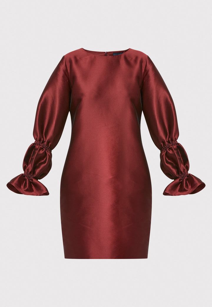 Step into the spotlight with Aurora, a chic short shift dress in a stunning mahogany red hue. This stylish piece features a statement puff-ball sleeve , side seam pockets, and falls above the knee. Crafted from a silk blend taffeta. Make a grand entrance with Aurora.