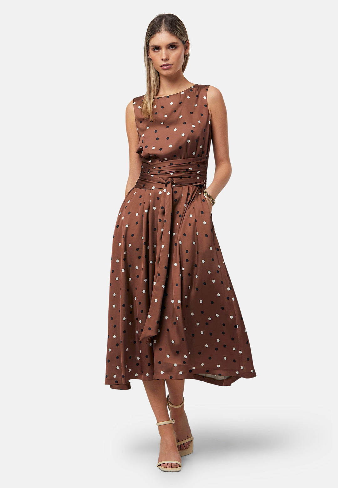 Have your very own Julia Roberts moment in our take of the iconic Pretty Woman polkadot dress. Avril is a sleeveless dress in a brown base, black and white polkadot print. The waist is accentuated with a gathered tied detail. Designed with a flattering empire line silhouette that gracefully skims the body, culminating in a chic mid-calf hemline. Perfect for date nights and semi-formal occasions.