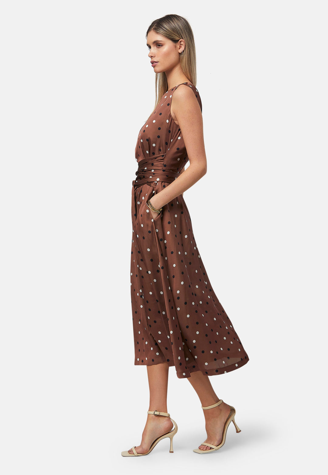 Have your very own Julia Roberts moment in our take of the iconic Pretty Woman polkadot dress. Avril is a sleeveless dress in a brown base, black and white polkadot print. The waist is accentuated with a gathered tied detail. Designed with a flattering empire line silhouette that gracefully skims the body, culminating in a chic mid-calf hemline. Perfect for date nights and semi-formal occasions.