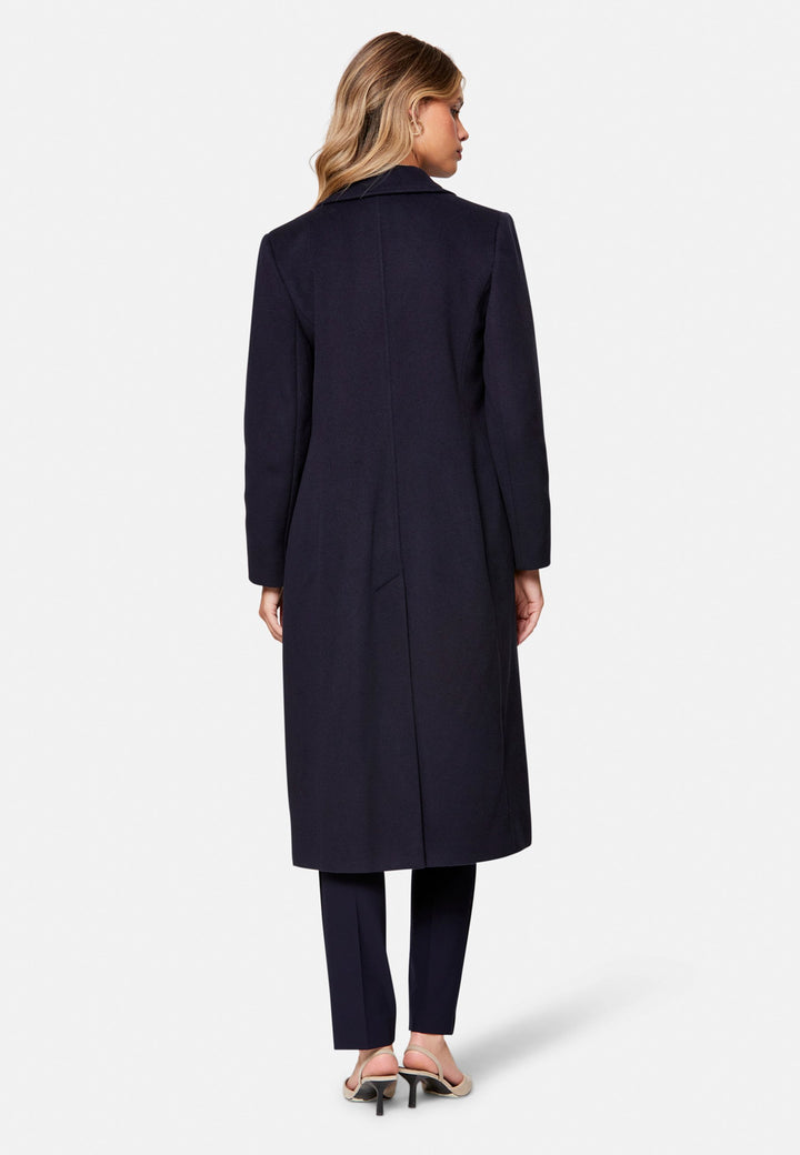 woman wearing double breast cashmere coat in navy