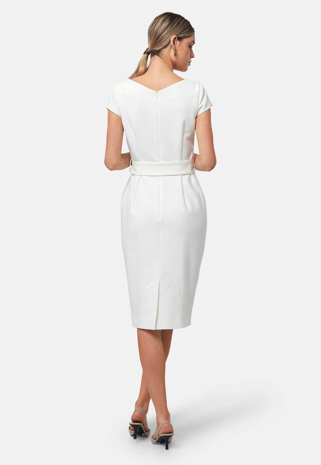 Bianca, a capped-sleeve dress featuring a slash neck and pencil skirt silhouette. Accompanied by a detachable belt featuring gold trimmed pearlescent buttons for the option of a more cinched waistline. Crafted from our signature tricotine with a touch of elastane, ensuring both comfort and movement whilst maintaining a flattering structure. Pair with a trench coat and heels for a chic look.