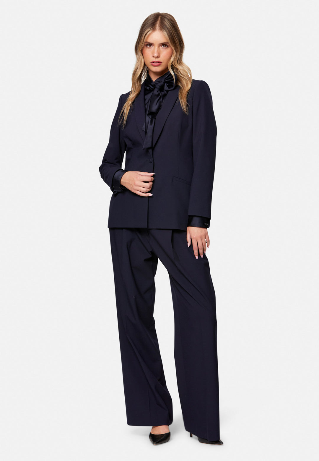Darcie, the wear-everywhere blazer. Single-breasted with a tonal one-button fastening, tuxedo-inspired shawl collar and neat welt pockets. Cut to a longline, semi-fitted silhouette that flatters over dresses or trousers. Pair with the coordinating Lyra trousers for a modern suit, or throw on with denim at the weekend.