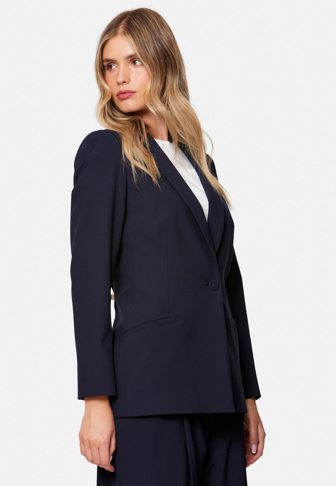Darcie, the wear-everywhere blazer. Single-breasted with a tonal one-button fastening, tuxedo-inspired shawl collar and neat welt pockets. Cut to a longline, semi-fitted silhouette that flatters over dresses or trousers. Pair with the coordinating Lyra trousers for a modern suit, or throw on with denim at the weekend.