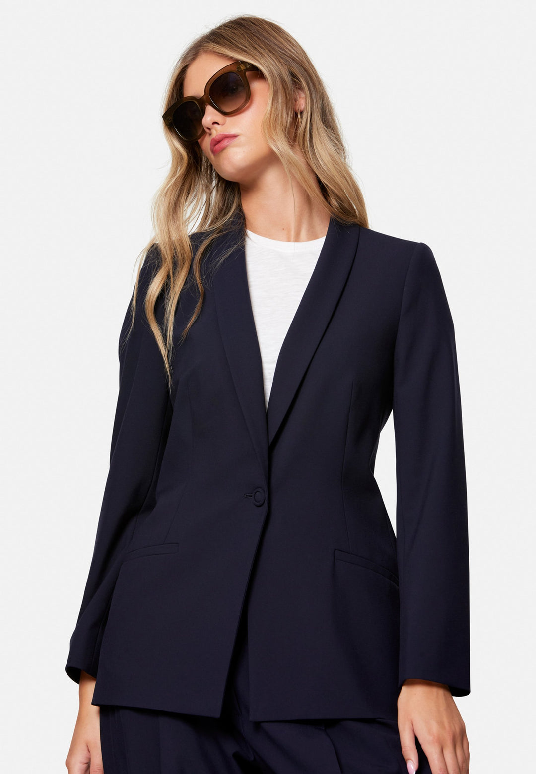Darcie, the wear-everywhere blazer. Single-breasted with a tonal one-button fastening, tuxedo-inspired shawl collar and neat welt pockets. Cut to a longline, semi-fitted silhouette that flatters over dresses or trousers. Pair with the coordinating Lyra trousers for a modern suit, or throw on with denim at the weekend.