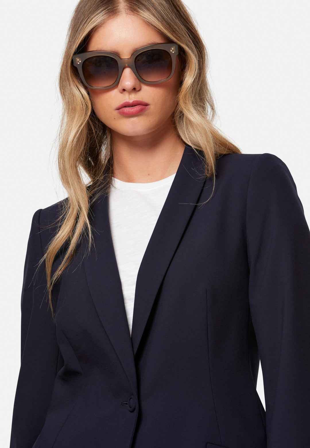 Darcie, the wear-everywhere blazer. Single-breasted with a tonal one-button fastening, tuxedo-inspired shawl collar and neat welt pockets. Cut to a longline, semi-fitted silhouette that flatters over dresses or trousers. Pair with the coordinating Lyra trousers for a modern suit, or throw on with denim at the weekend.