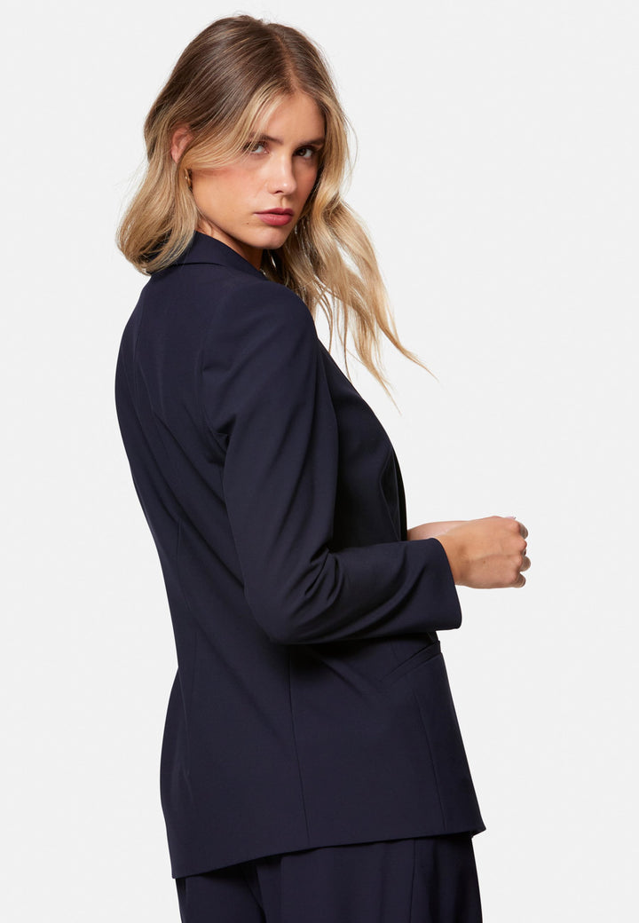 Darcie, the wear-everywhere blazer. Single-breasted with a tonal one-button fastening, tuxedo-inspired shawl collar and neat welt pockets. Cut to a longline, semi-fitted silhouette that flatters over dresses or trousers. Pair with the coordinating Lyra trousers for a modern suit, or throw on with denim at the weekend.