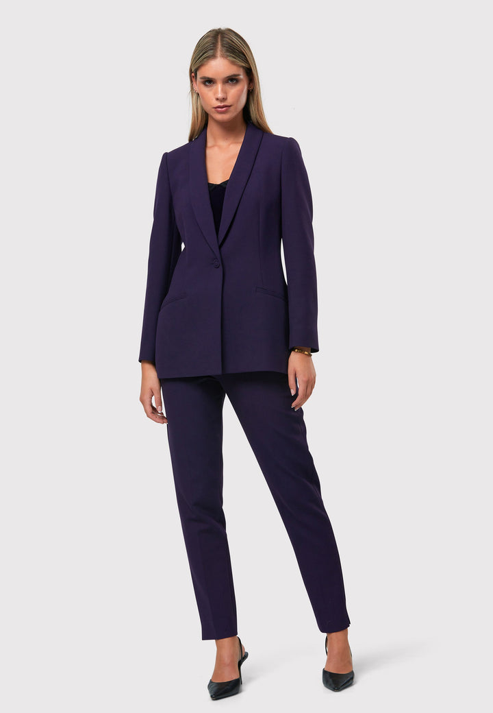 Introducing the Darcie Twilight Plum Jacket, a timeless expression of elegance. This impeccably tailored tuxedo jacket features a seamless shawl collar and welt pockets for a classic touch. The semi-fitted silhouette is enhanced by a single-button closure, ensuring a flattering and sophisticated look. Crafted from our signature tricotine with a hint of stretch, it promises comfort and ease. Complete your polished ensemble by pairing it with the matching Jill Twilight Plum Trouser.