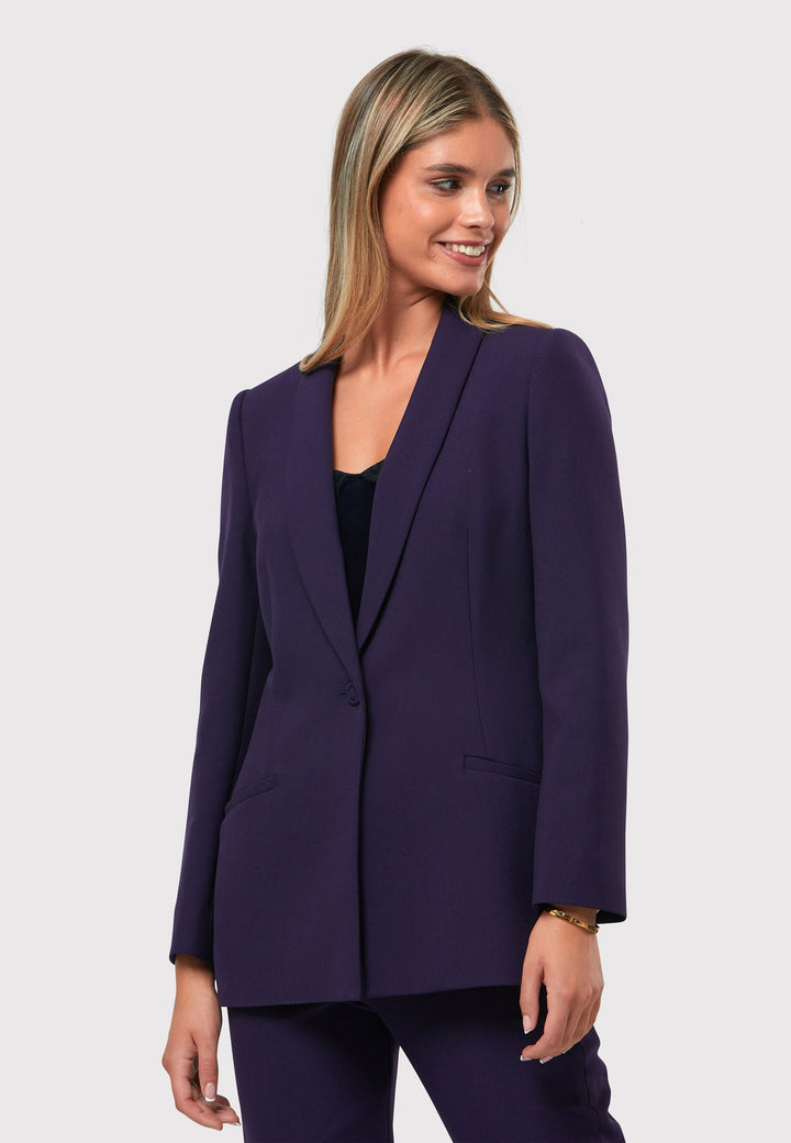 Introducing the Darcie Twilight Plum Jacket, a timeless expression of elegance. This impeccably tailored tuxedo jacket features a seamless shawl collar and welt pockets for a classic touch. The semi-fitted silhouette is enhanced by a single-button closure, ensuring a flattering and sophisticated look. Crafted from our signature tricotine with a hint of stretch, it promises comfort and ease. Complete your polished ensemble by pairing it with the matching Jill Twilight Plum Trouser.