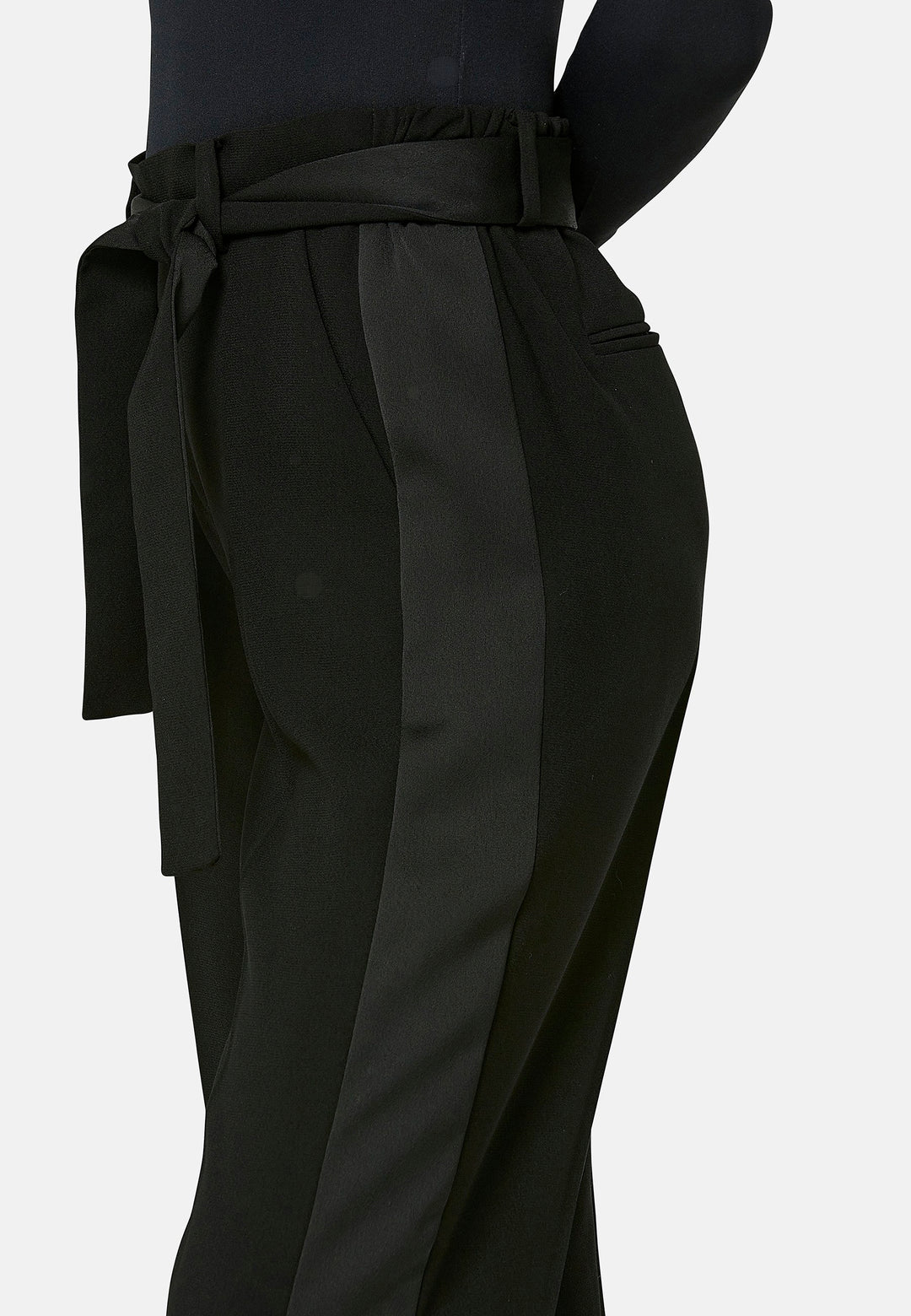 Delilah, Black flat front straight leg trouser with side seam pockets in fluid satin back crepe. Feature a detachable self-fabric belt and a satin stripe along the side seam of the leg. Coordinate with black sparkly tops or matching Lal top for a relaxed take on 'after six' dressing.