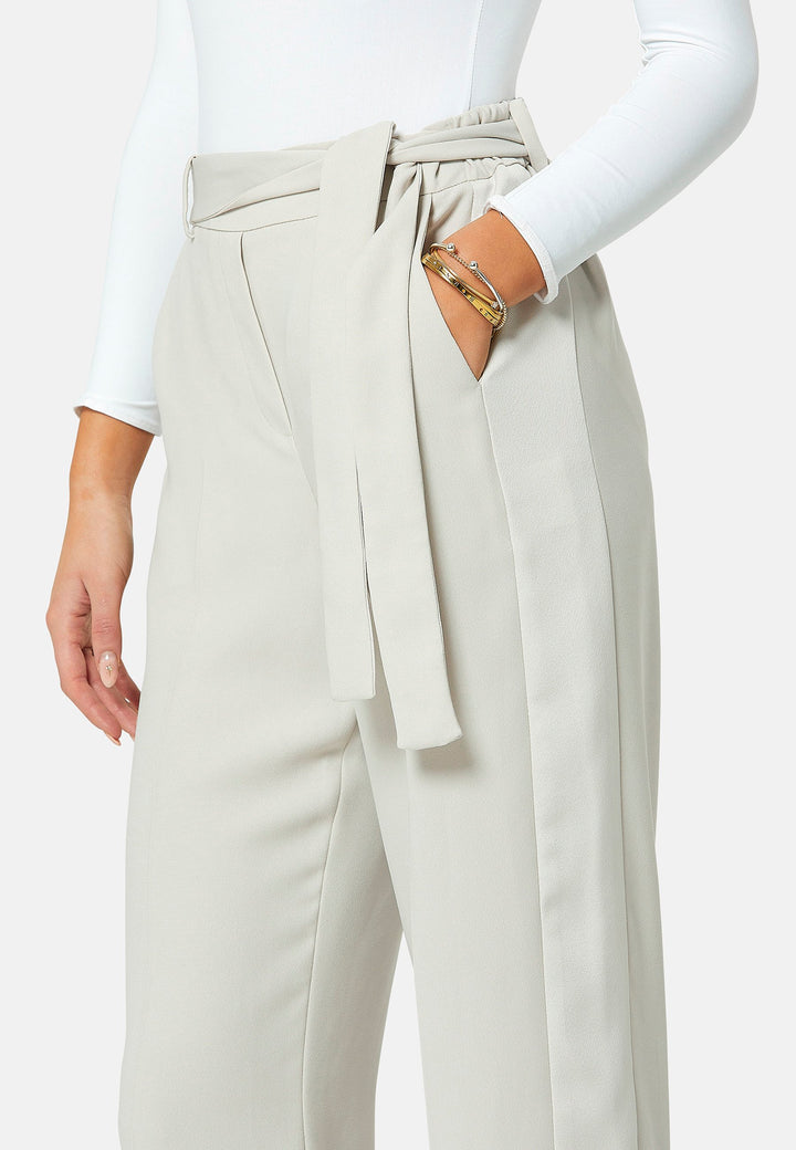 Delilah, Stone flat front straight leg trouser with side seam pockets in fluid satin back crepe. Feature a detachable self-fabric belt and a satin stripe along the side seam of the leg. Coordinate with the white timeless tops or matching Lal top for a relaxed take on 'after six' dressing.