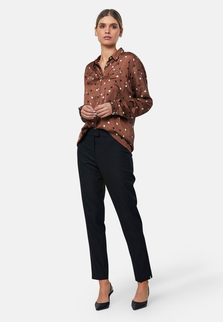 Elevate your day edit with the Ella Brown Polkadot shirt. Featuring patch pockets and a back center box pleat. Tuck into the black Jill trousers, add heels and a blazer, to create a refined daytime look that easily transitions into evening plans.