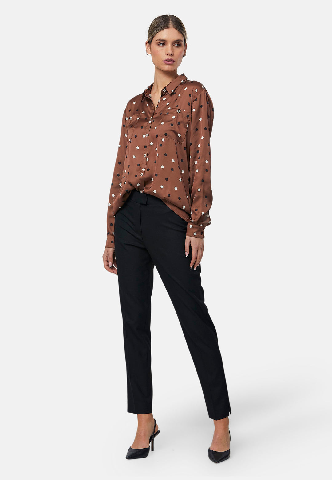 Elevate your day edit with the Ella Brown Polkadot shirt. Featuring patch pockets and a back center box pleat. Tuck into the black Jill trousers, add heels and a blazer, to create a refined daytime look that easily transitions into evening plans.