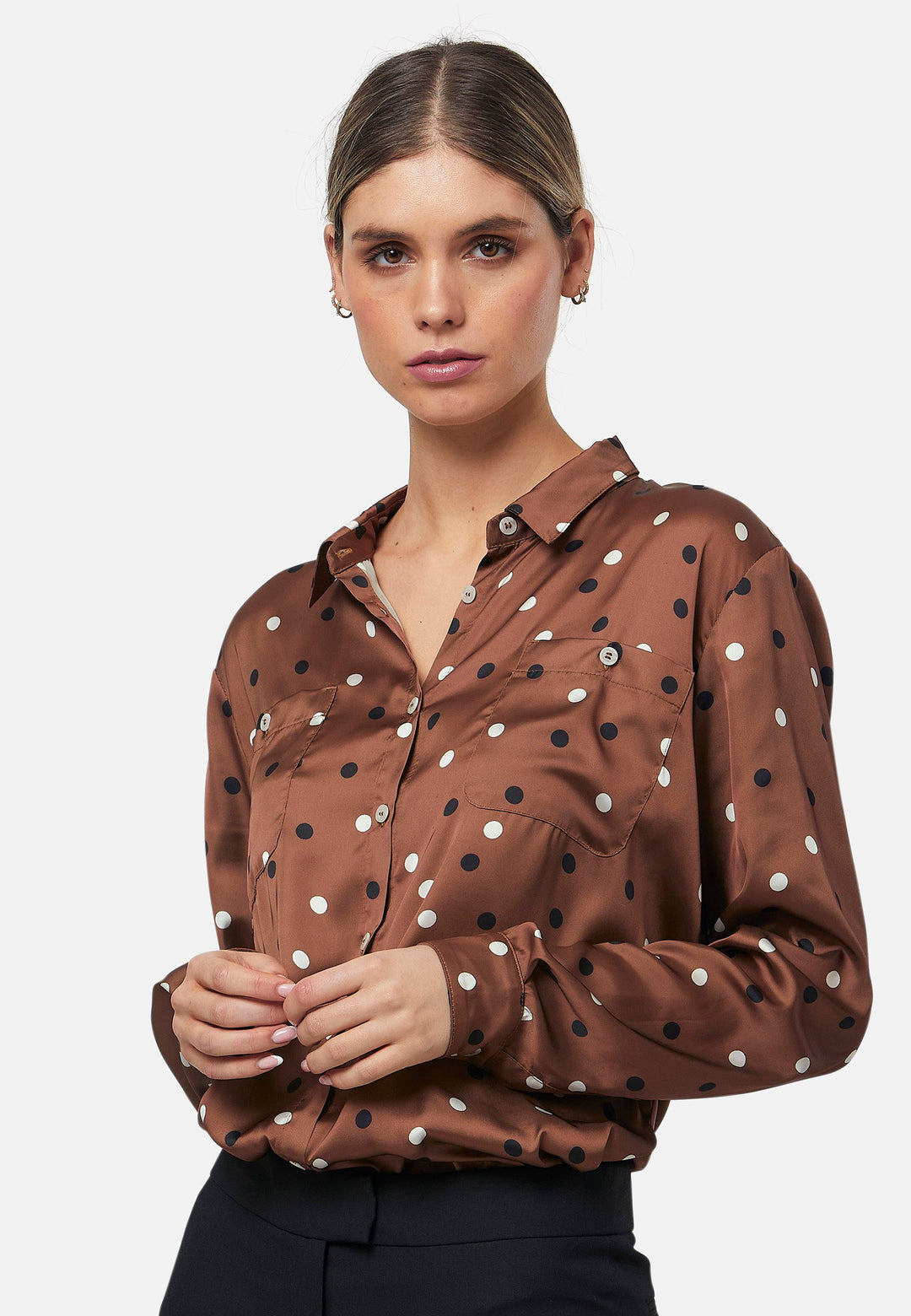 Elevate your day edit with the Ella Brown Polkadot shirt. Featuring patch pockets and a back center box pleat. Tuck into the black Jill trousers, add heels and a blazer, to create a refined daytime look that easily transitions into evening plans.