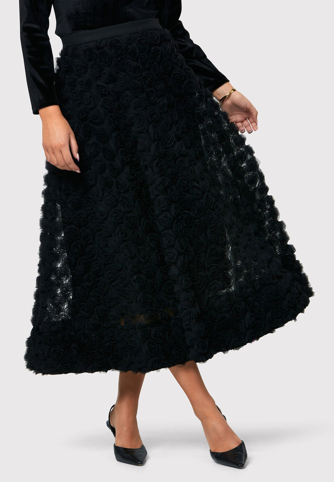 Make a statement with the Black Felicity Skirt. An ankle grazing full skirt crafted in an sculptural rose detailed fabric. Pair it with a fitted timeless black top for a chic look, perfect for any special occasion.