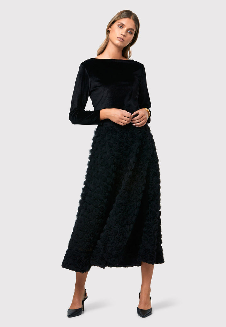 Make a statement with the Black Felicity Skirt. An ankle grazing full skirt crafted in an sculptural rose detailed fabric. Pair it with a fitted timeless black top for a chic look, perfect for any special occasion.