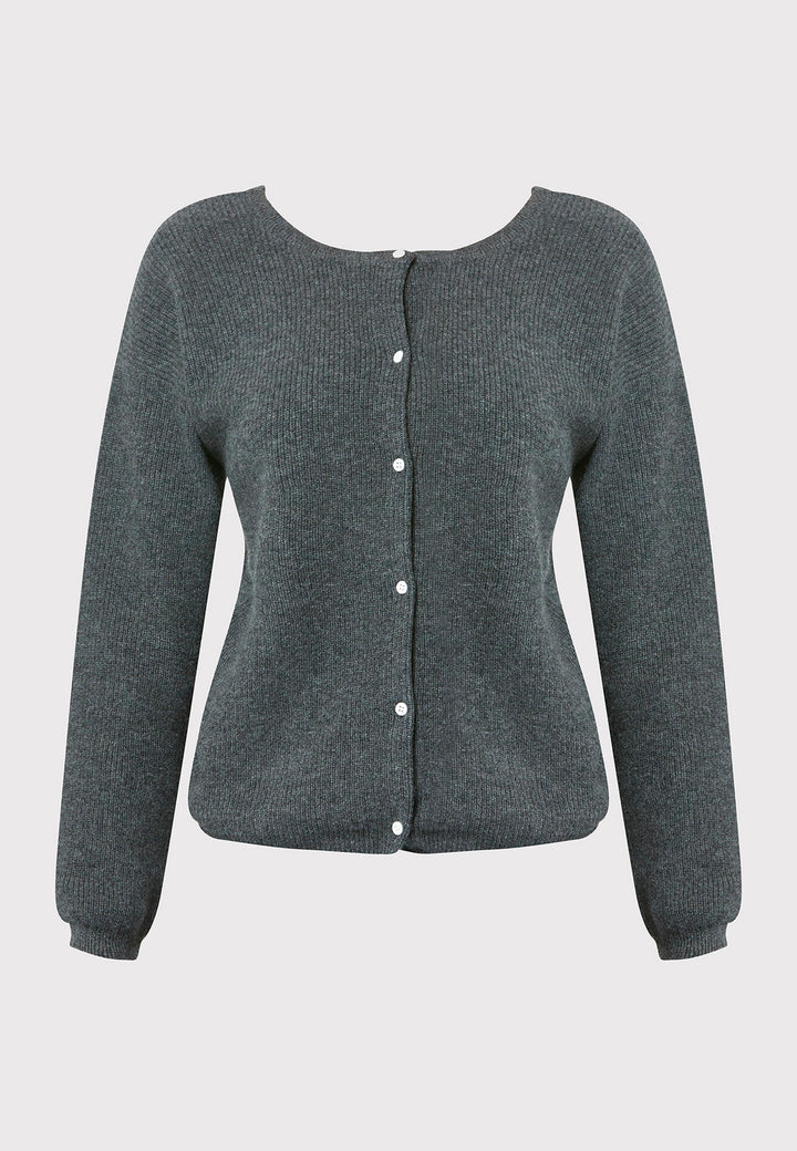 The Greta Cashmere Cardigan in Charcoal Grey is a versatile and stylish addition to your wardrobe. Featuring ribbed detailing and a tidy finish, this reversible piece can be worn as a button-back jumper for a chic, contemporary look or layered as a cardigan over the Marlena Cashmere Sweater-Vest for a coordinated outfit. Crafted from luxurious cashmere, this cardigan offers both comfort and sophistication, perfect for any occasion.