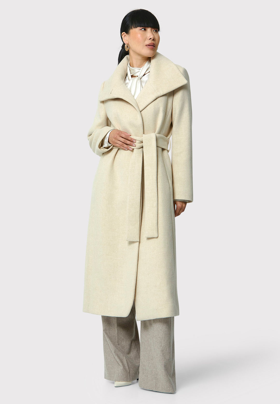 Stay warm and stylish with the Hazel Winter White Coat. Crafted from a luxurious wool blend melton, this coat features a large funnel which falls to a shawl collar and a belted waist for a flattering silhouette. Pair it with tailored trousers or a chic dress for a sophisticated winter look.