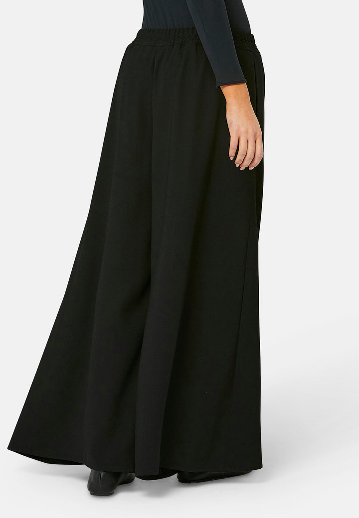 Imogen, black culottes in a fluid satin back crepe. Feature a flowy wide-leg, elasticated waistband and side pockets. A relaxed yet dressy look. Coordinate with black sparkly tops and matching Lydiah trench for a complete outfit.