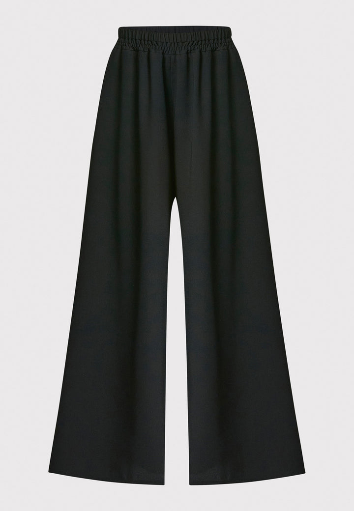 Imogen, black culottes in a fluid satin back crepe. Feature a flowy wide-leg, elasticated waistband and side pockets. A relaxed yet dressy look. Coordinate with black sparkly tops and matching Lydiah trench for a complete outfit.