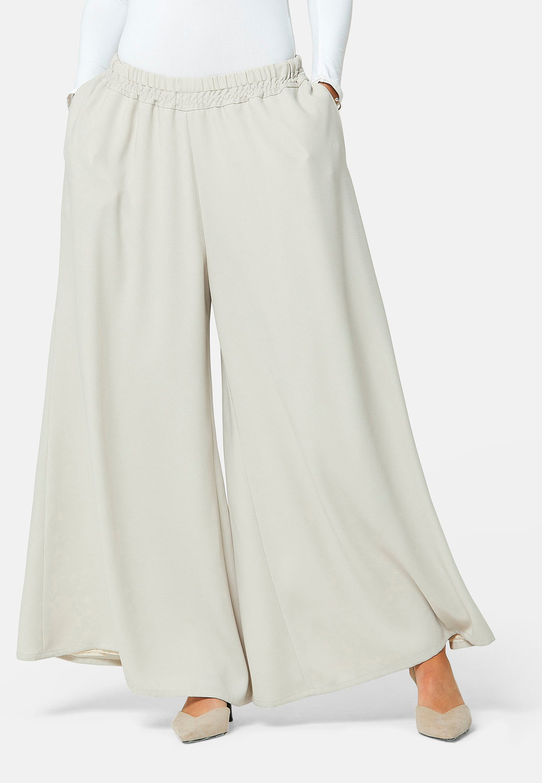 Imogen, Stone culottes in a fluid satin back crepe. Feature a flowy wide-leg, elasticated waistband and side pockets. A relaxed yet dressy look. Coordinate with white timeless tops and matching Lydiah trench for a complete outfit.