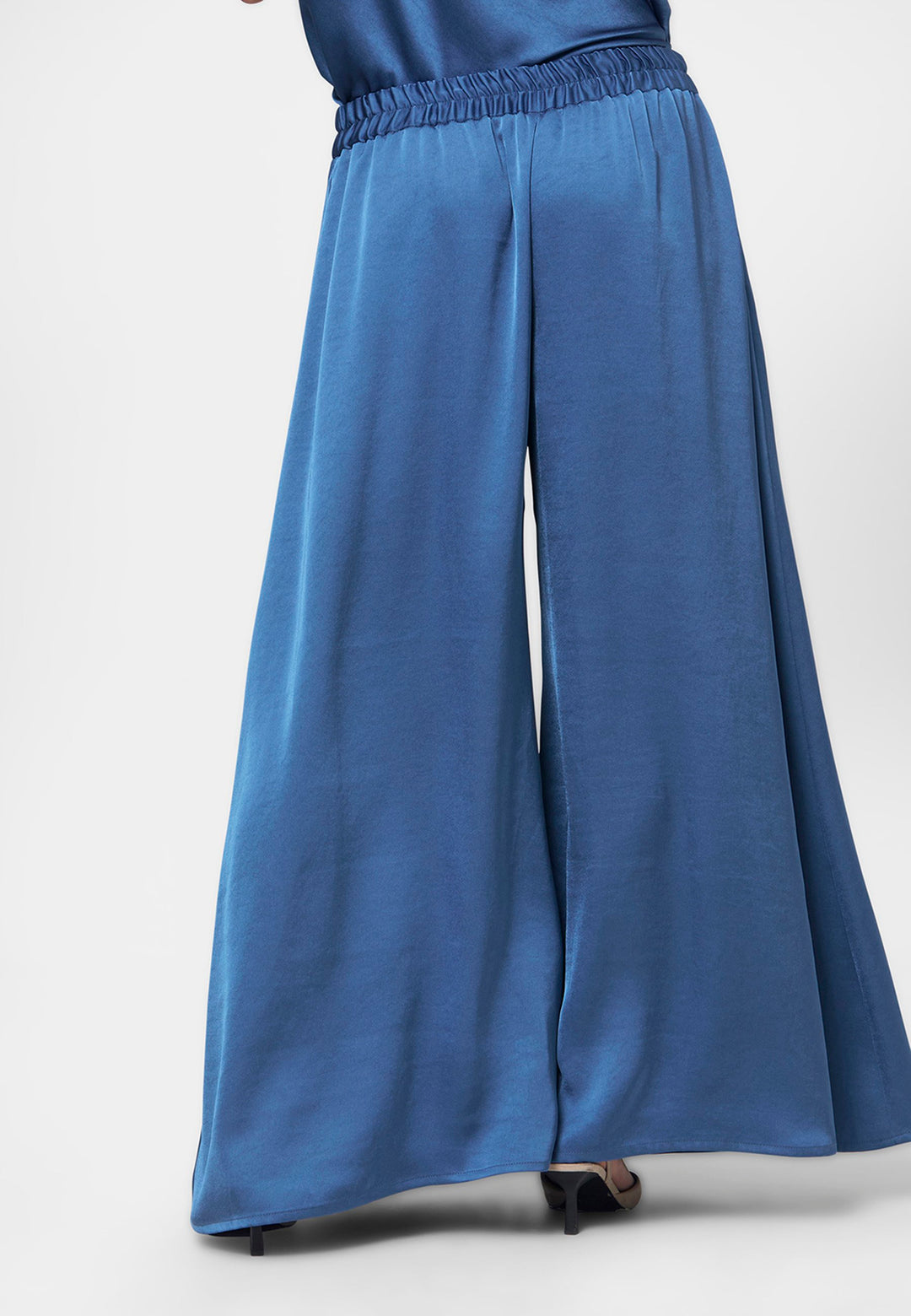 Woman wearing silk-touch satin in storm blue pants