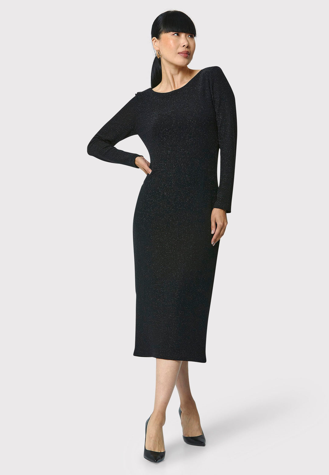 Introducing the Jamie Black Shimmer Dress, an elegant bodycon piece with full-length sleeves. Made from sparkly black jersey fabric, it features a slash neck with a slight V-back for added allure. Its midi length perfectly balances classic and modern styles. Ideal for any occasion, this dress adds a touch of glamour to your look.