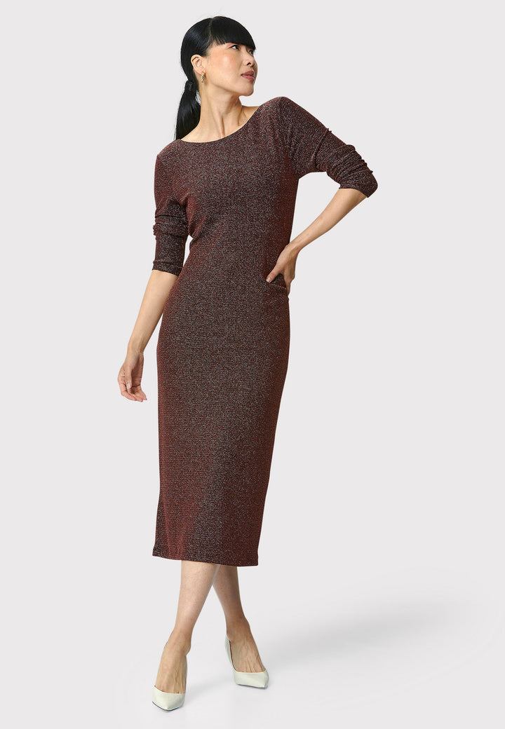 Introducing the Jamie Copper Shimmer Dress, an elegant bodycon piece with full-length sleeves. Made from sparkly black jersey fabric, it features a slash neck with a slight V-back for added allure. Its midi length perfectly balances classic and modern styles. Ideal for any occasion, this dress adds a touch of glamour to your look.