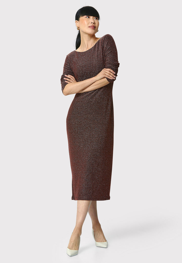 Introducing the Jamie Copper Shimmer Dress, an elegant bodycon piece with full-length sleeves. Made from sparkly black jersey fabric, it features a slash neck with a slight V-back for added allure. Its midi length perfectly balances classic and modern styles. Ideal for any occasion, this dress adds a touch of glamour to your look.