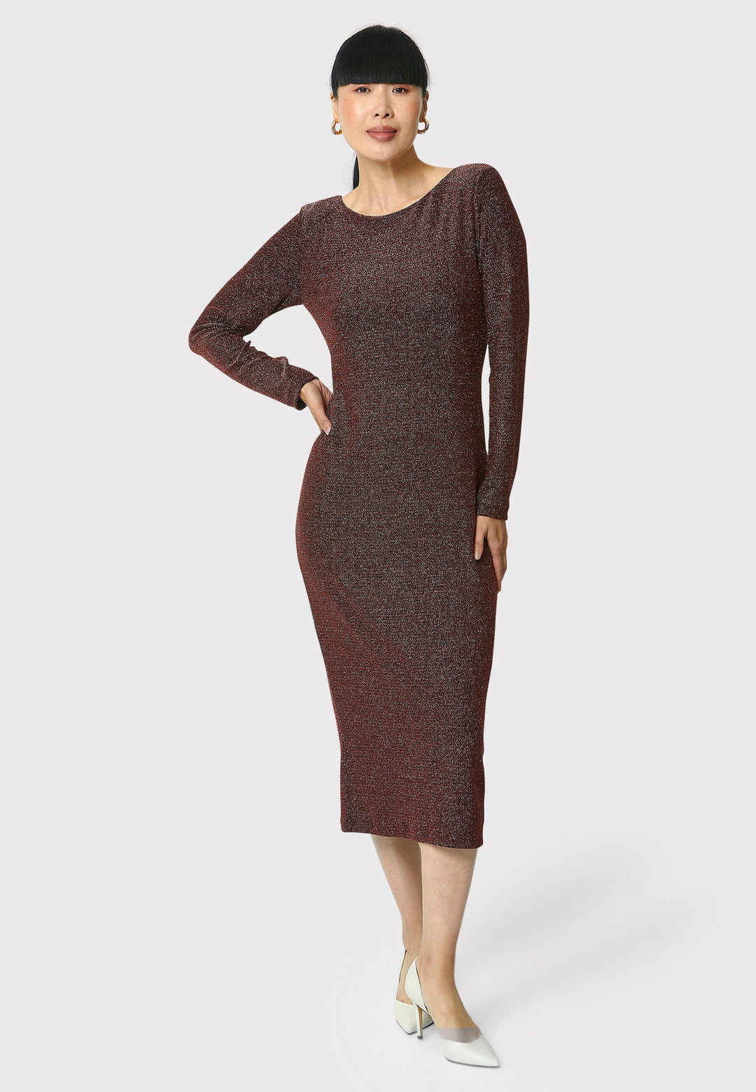 Introducing the Jamie Copper Shimmer Dress, an elegant bodycon piece with full-length sleeves. Made from sparkly black jersey fabric, it features a slash neck with a slight V-back for added allure. Its midi length perfectly balances classic and modern styles. Ideal for any occasion, this dress adds a touch of glamour to your look.