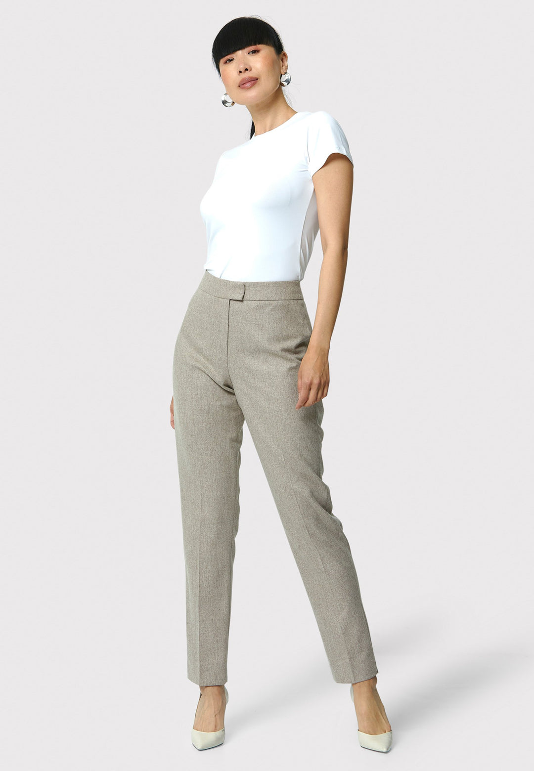 Introducing Jill in melange mink, a sophisticated addition to your wardrobe. These classic narrow-leg trousers features a tailored silhouette and an ankle-grazing length. The clean, flat front sits naturally at the waist, complemented by details like a jet pocket at the back and a slit hem. Pair with the Marlowe Melange Mink Jacket.