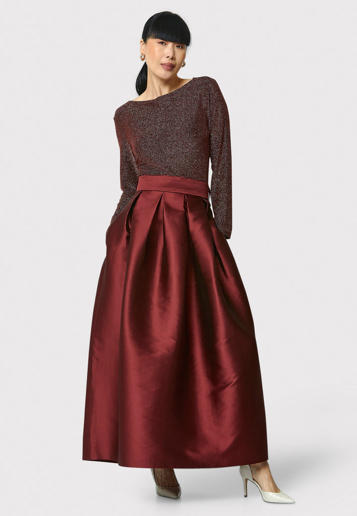 The Kennedy Mahogany Red Skirt is a sophisticated and chic piece inspired by 1950s fashion. This full-length A-line skirt features a structured design that captures the essence of iconic 50s style. Perfect for formal events and black tie weddings, the Kennedy Mahogany Red Skirt offers classic elegance with a modern twist.