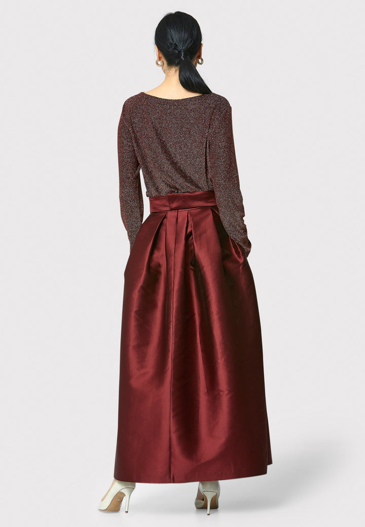 The Kennedy Mahogany Red Skirt is a sophisticated and chic piece inspired by 1950s fashion. This full-length A-line skirt features a structured design that captures the essence of iconic 50s style. Perfect for formal events and black tie weddings, the Kennedy Mahogany Red Skirt offers classic elegance with a modern twist.