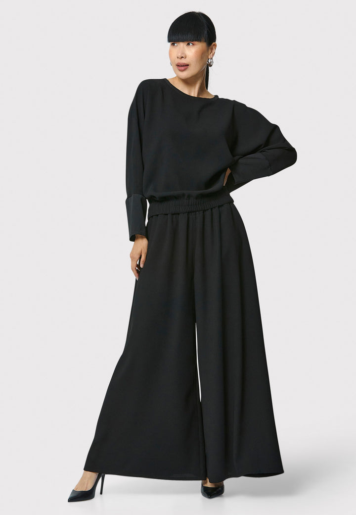 Lal, black top in fluid satin back crepe. A relaxed fit, elastic waistband, Dropped Shoulder sleeves, and satin cuffs. Wear with the coordinating Deliliah or Imogen Pant.