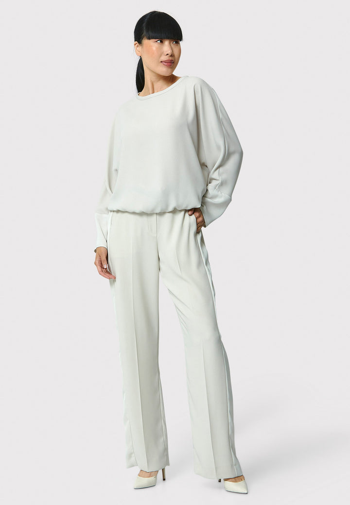 Lal, stone top in fluid satin back crepe. A relaxed fit, elastic waistband, Dropped Shoulder sleeves, and satin cuffs. Wear with the coordinating Deliliah or Imogen Pant.