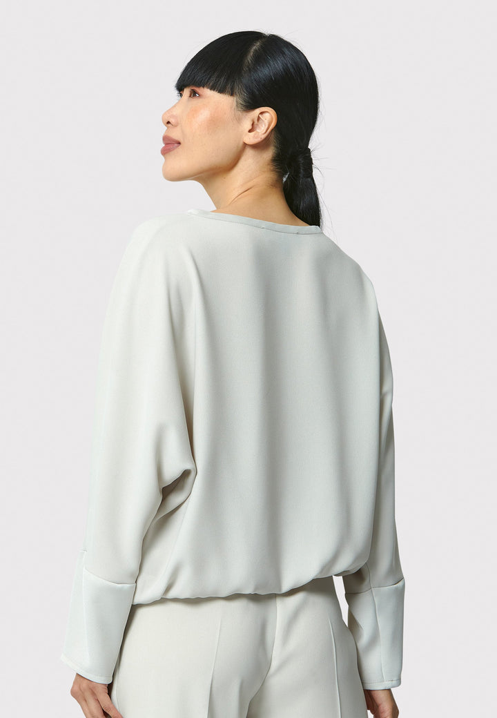 Lal, stone top in fluid satin back crepe. A relaxed fit, elastic waistband, Dropped Shoulder sleeves, and satin cuffs. Wear with the coordinating Deliliah or Imogen Pant.