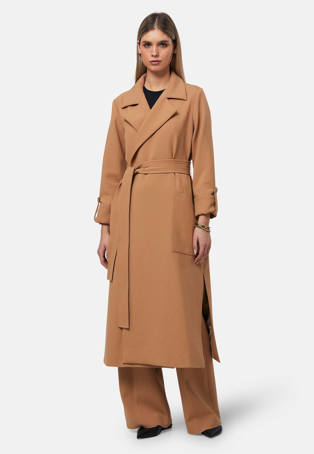 The Lydiah Coat is a minimalist trench style in camel. This coat features a relaxed, straight silhouette with a detachable self-tie belt, and front patch pockets. The design includes buttoned turn back cuffs and a wide lapel. Pair with our coordinating Lyra trouser for a chic monochromatic look.