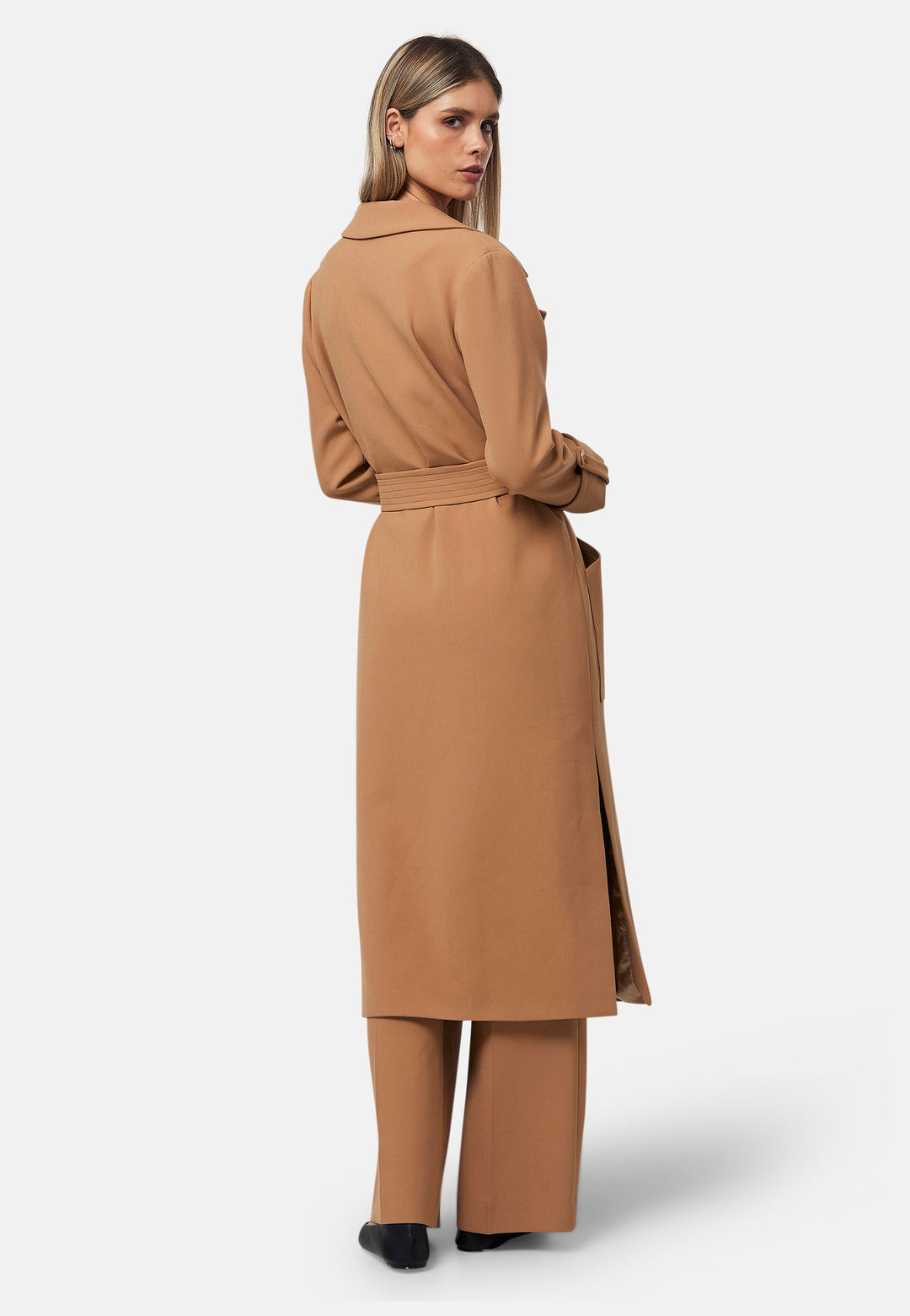 The Lydiah Coat is a minimalist trench style in camel. This coat features a relaxed, straight silhouette with a detachable self-tie belt, and front patch pockets. The design includes buttoned turn back cuffs and a wide lapel. Pair with our coordinating Lyra trouser for a chic monochromatic look.