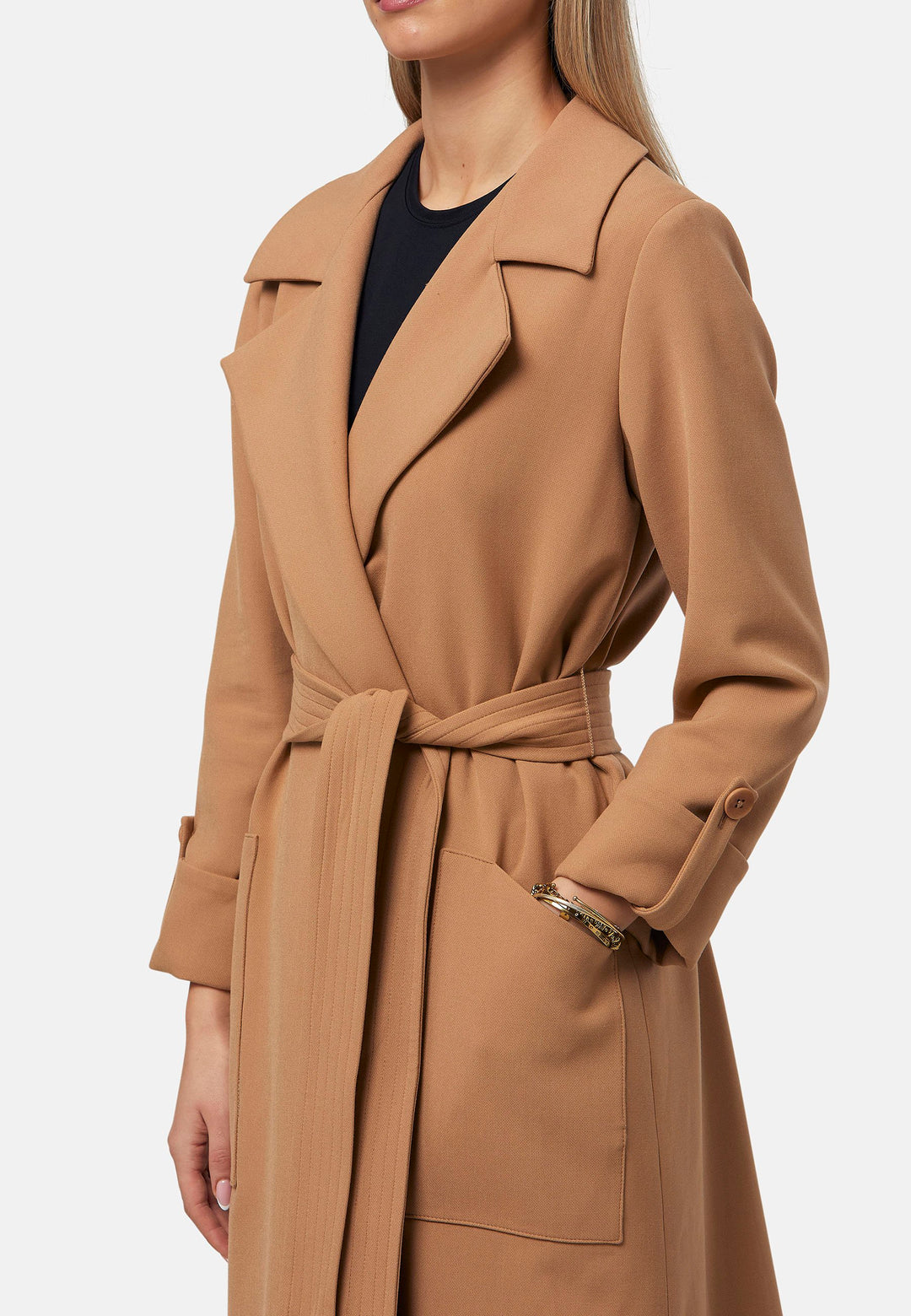 The Lydiah Coat is a minimalist trench style in camel. This coat features a relaxed, straight silhouette with a detachable self-tie belt, and front patch pockets. The design includes buttoned turn back cuffs and a wide lapel. Pair with our coordinating Lyra trouser for a chic monochromatic look.