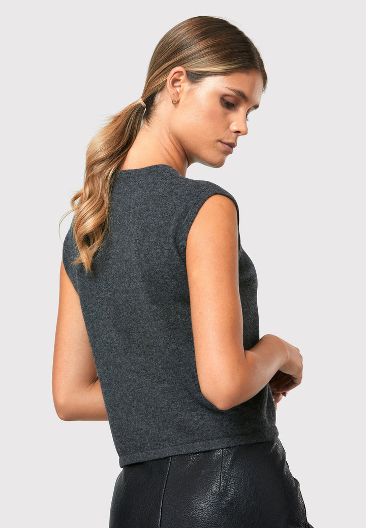 The Marlena Charcoal Grey Cashmere Sweater-Vest is a sleeveless round-neck top that offers versatile styling options. Wear it as a simple underpinning for the matching ballet wrap to complete a coordinated look. Alternatively, layer it as a sweater vest over your favorite crisp white shirts for a stylish and contemporary outfit. Made from luxurious cashmere, the Marlena Sweater-Vest adds an extra layer of comfort and sophistication to your wardrobe.