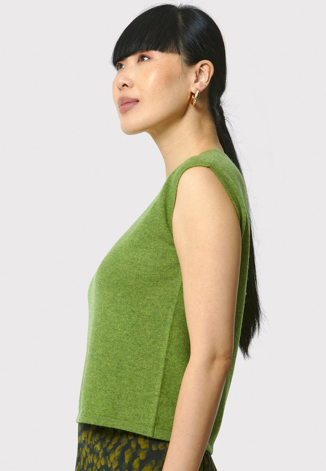 The Marlena Chartreuse Green Cashmere Sweater-Vest is a sleeveless, round-neck top that offers versatile styling options. Wear it as a simple underpinning for the matching Greta cardigan to complete a coordinated look. Alternatively, layer it as a sweater vest over your favorite crisp white shirts for a stylish and contemporary outfit. Made from luxurious cashmere, the Marlena Sweater-Vest adds an extra layer of comfort and sophistication to your wardrobe.