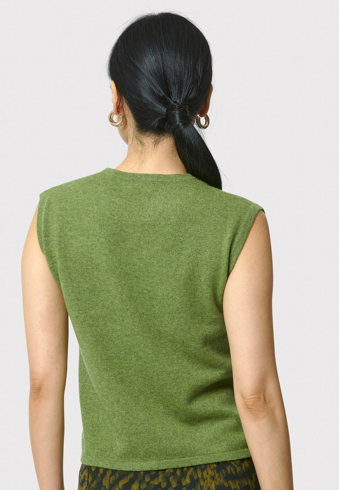 The Marlena Chartreuse Green Cashmere Sweater-Vest is a sleeveless, round-neck top that offers versatile styling options. Wear it as a simple underpinning for the matching Greta cardigan to complete a coordinated look. Alternatively, layer it as a sweater vest over your favorite crisp white shirts for a stylish and contemporary outfit. Made from luxurious cashmere, the Marlena Sweater-Vest adds an extra layer of comfort and sophistication to your wardrobe.