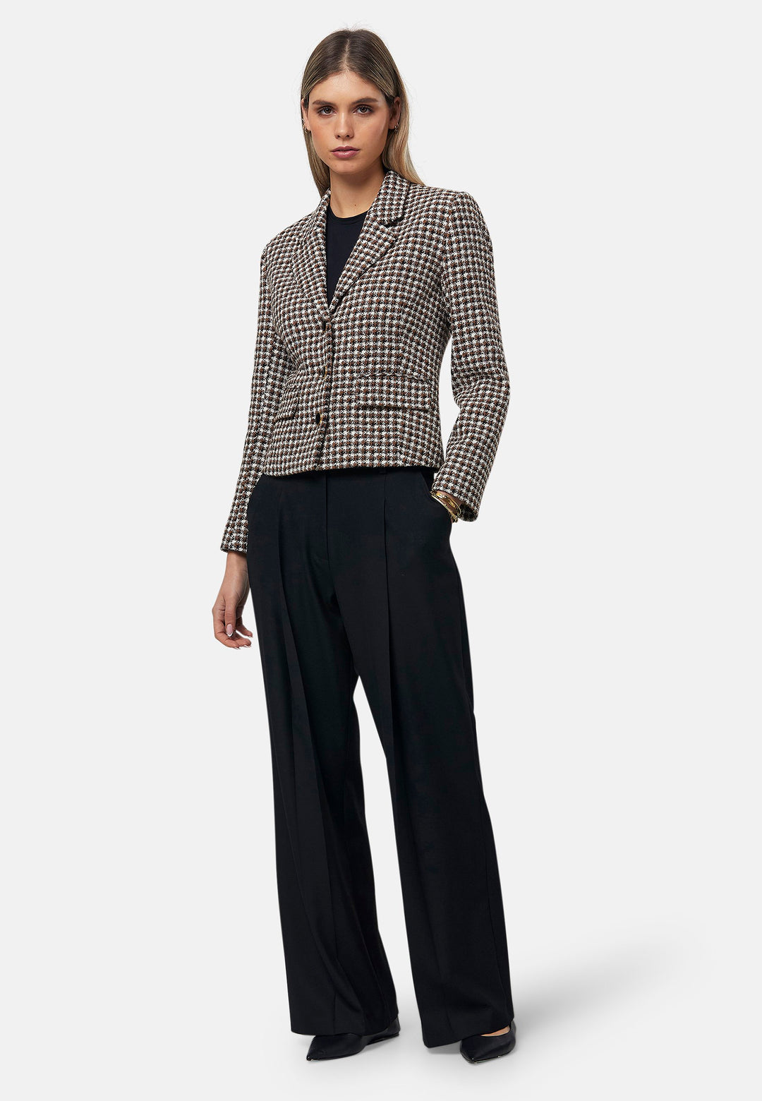 This bouclé tailored blazer features a classic houndstooth pattern in earthy brown, black, and white tones. Designed with a structured fit, it includes a notched lapel, three-button front closure, and flap pockets for a timeless look. Perfect for elevating both office and casual outfits.