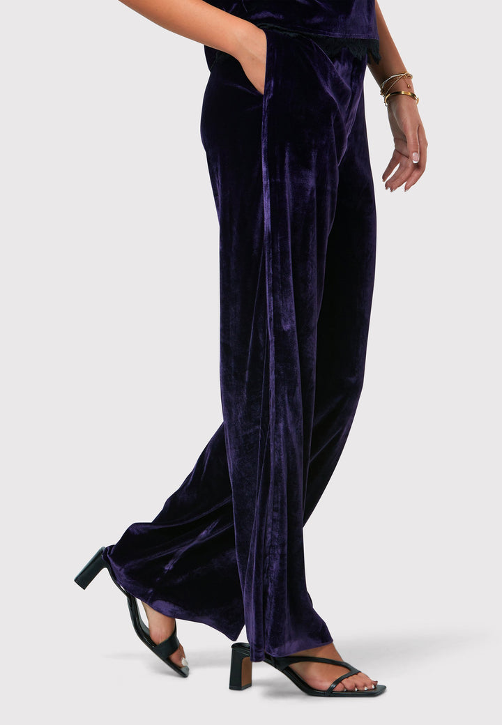 Indulge in luxurious comfort with our twilight plum wide-leg trousers. Flat-front trousers sit perfectly at the natural waist and include side pockets. Made from a premium purple tone velvet, a blend of silk and viscose, they exude elegance and sophistication.