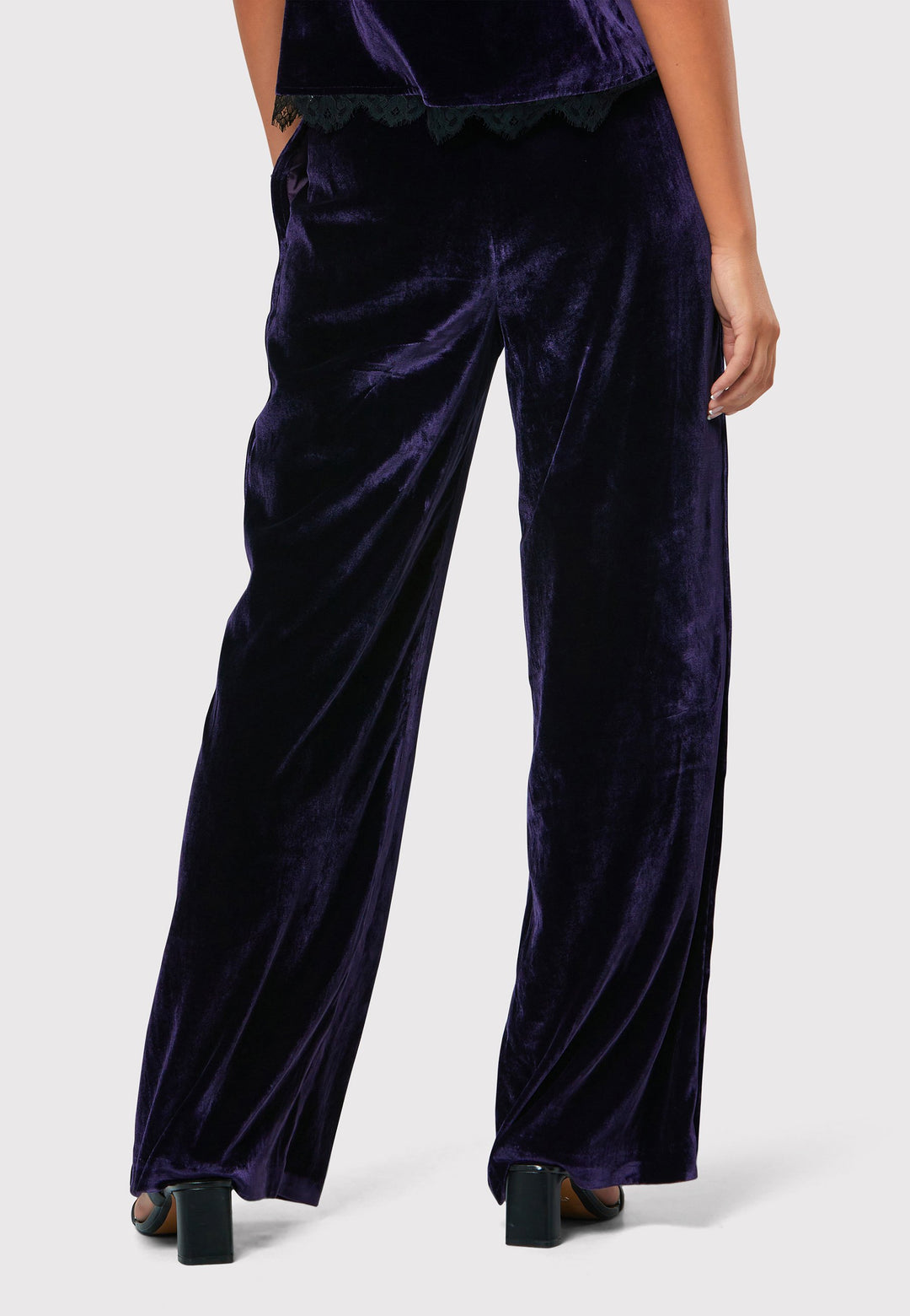 Indulge in luxurious comfort with our twilight plum wide-leg trousers. Flat-front trousers sit perfectly at the natural waist and include side pockets. Made from a premium purple tone velvet, a blend of silk and viscose, they exude elegance and sophistication.