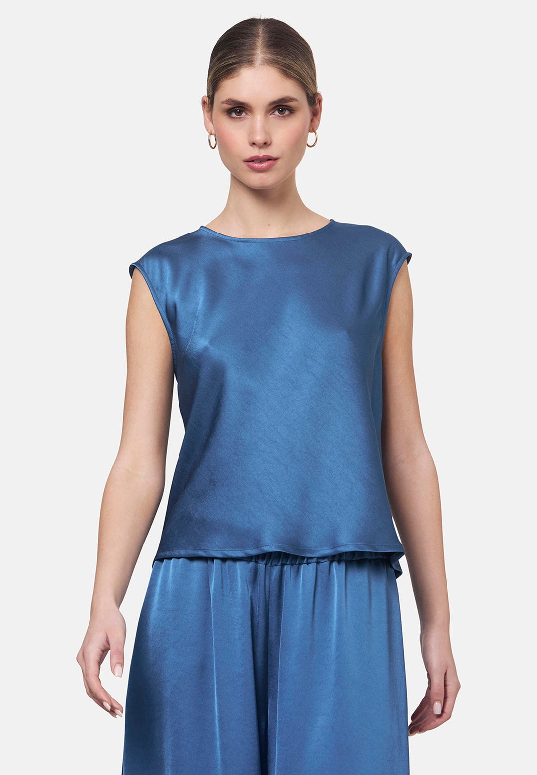 Woman wearing silk-touch satin in storm blue top