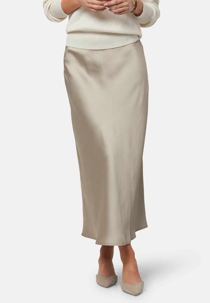 The Peyton Coffee satin skirt, a stunning mid-calf length piece. With its form-flattering high-waisted silhouette and luxurious coffee satin fabric, this skirt exudes elegance. The bias cut and elasticated waistband add extra comfort and stretch. Perfect for special occasions or elevated everyday wear, it captivates with its timeless appeal. Pair it with the Berna top to leave a lasting impression wherever you go.