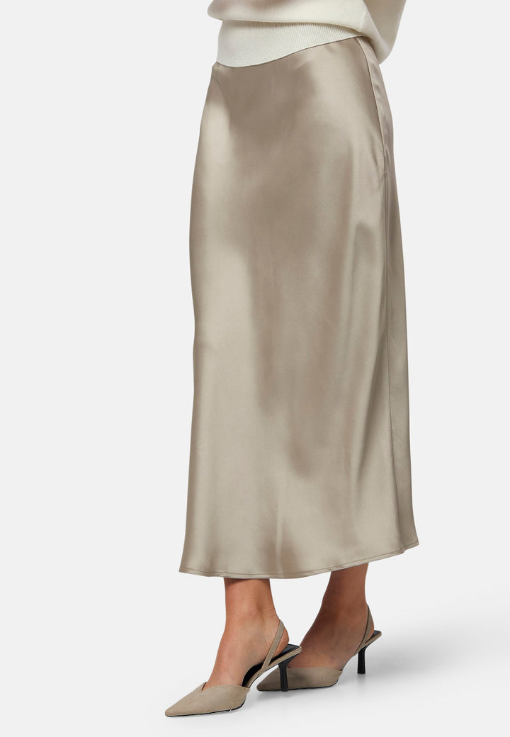 The Peyton Coffee satin skirt, a stunning mid-calf length piece. With its form-flattering high-waisted silhouette and luxurious coffee satin fabric, this skirt exudes elegance. The bias cut and elasticated waistband add extra comfort and stretch. Perfect for special occasions or elevated everyday wear, it captivates with its timeless appeal. Pair it with the Berna top to leave a lasting impression wherever you go.